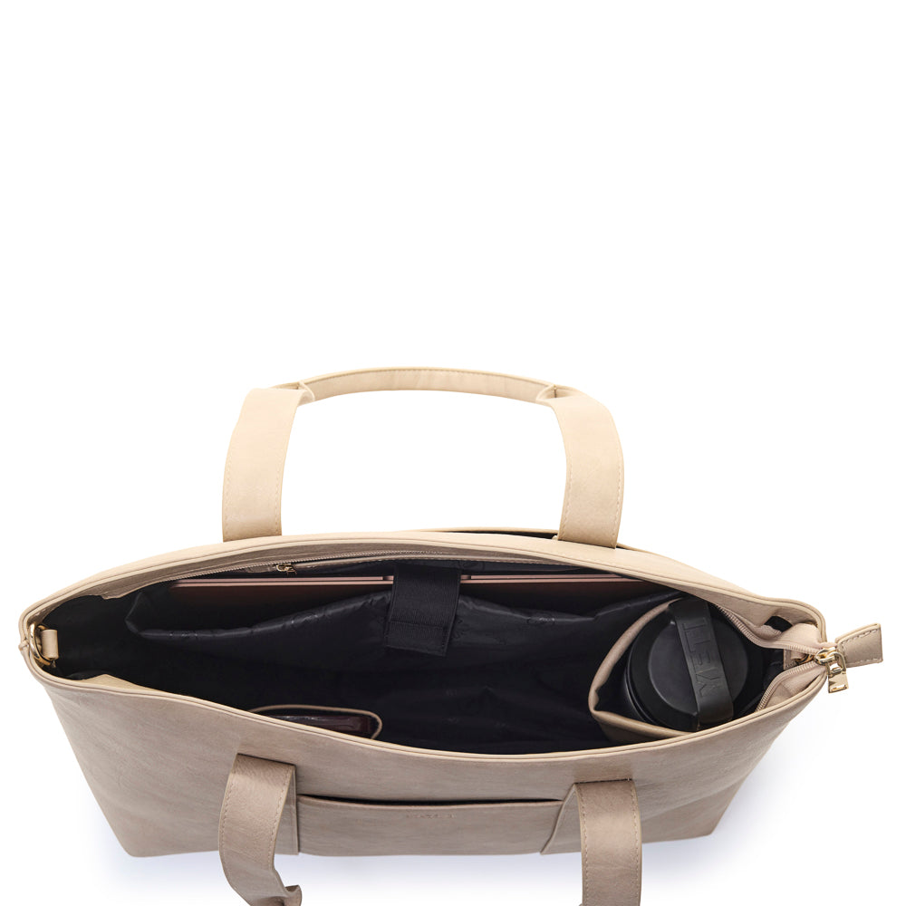 Beige handbag with black interior on a white background