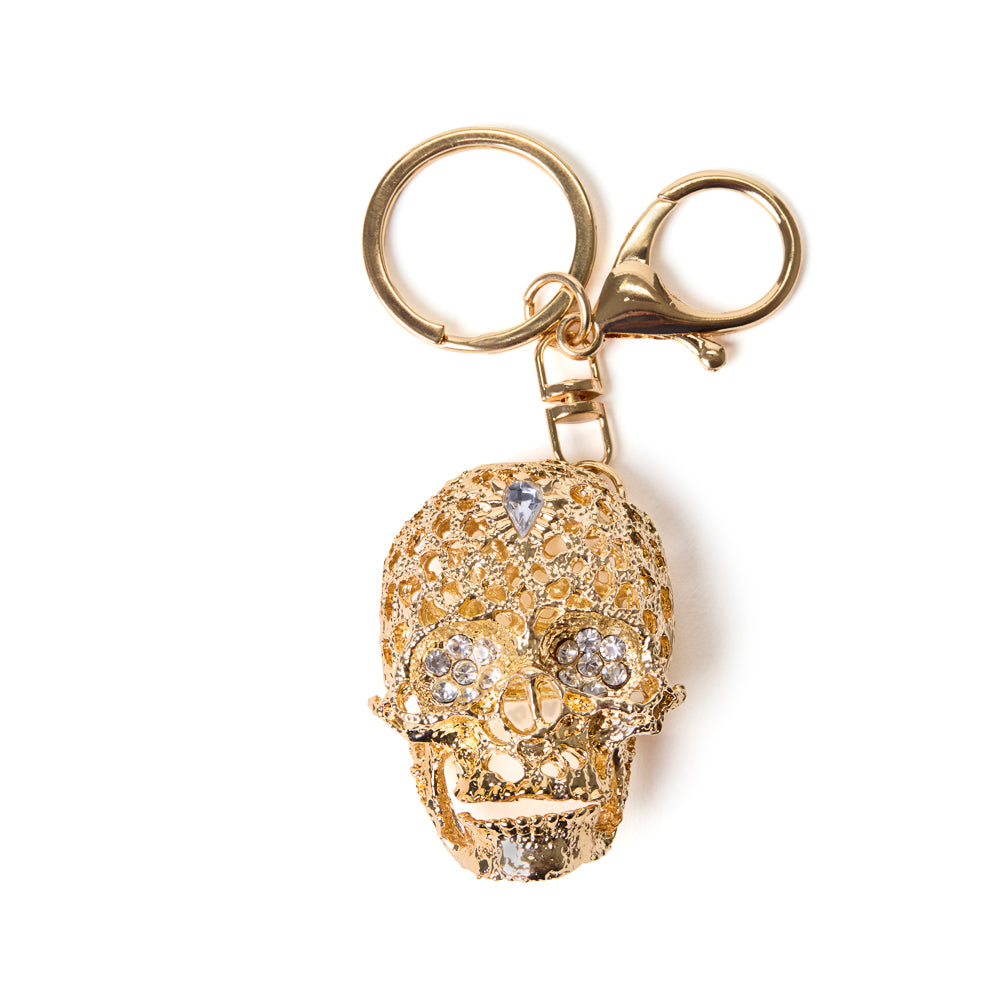 Gold skull bag charm and keychain with gemstones on a white background